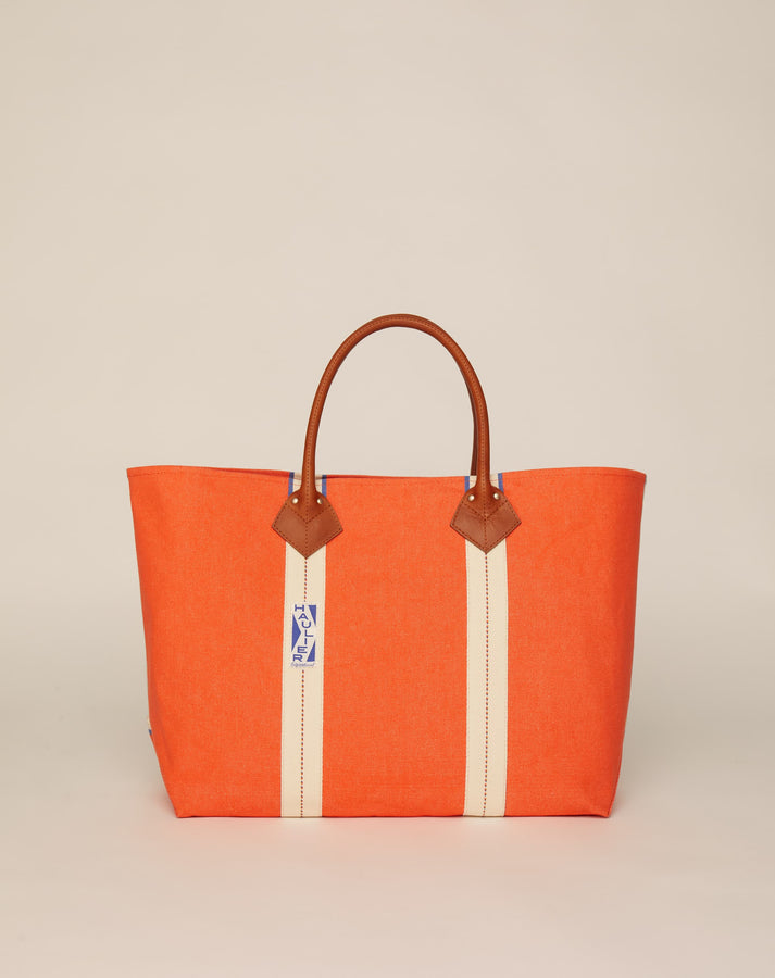 Image of classic canvas tote bag in bright orange colour with tan leather handles and contrasting natural ecru stripes.