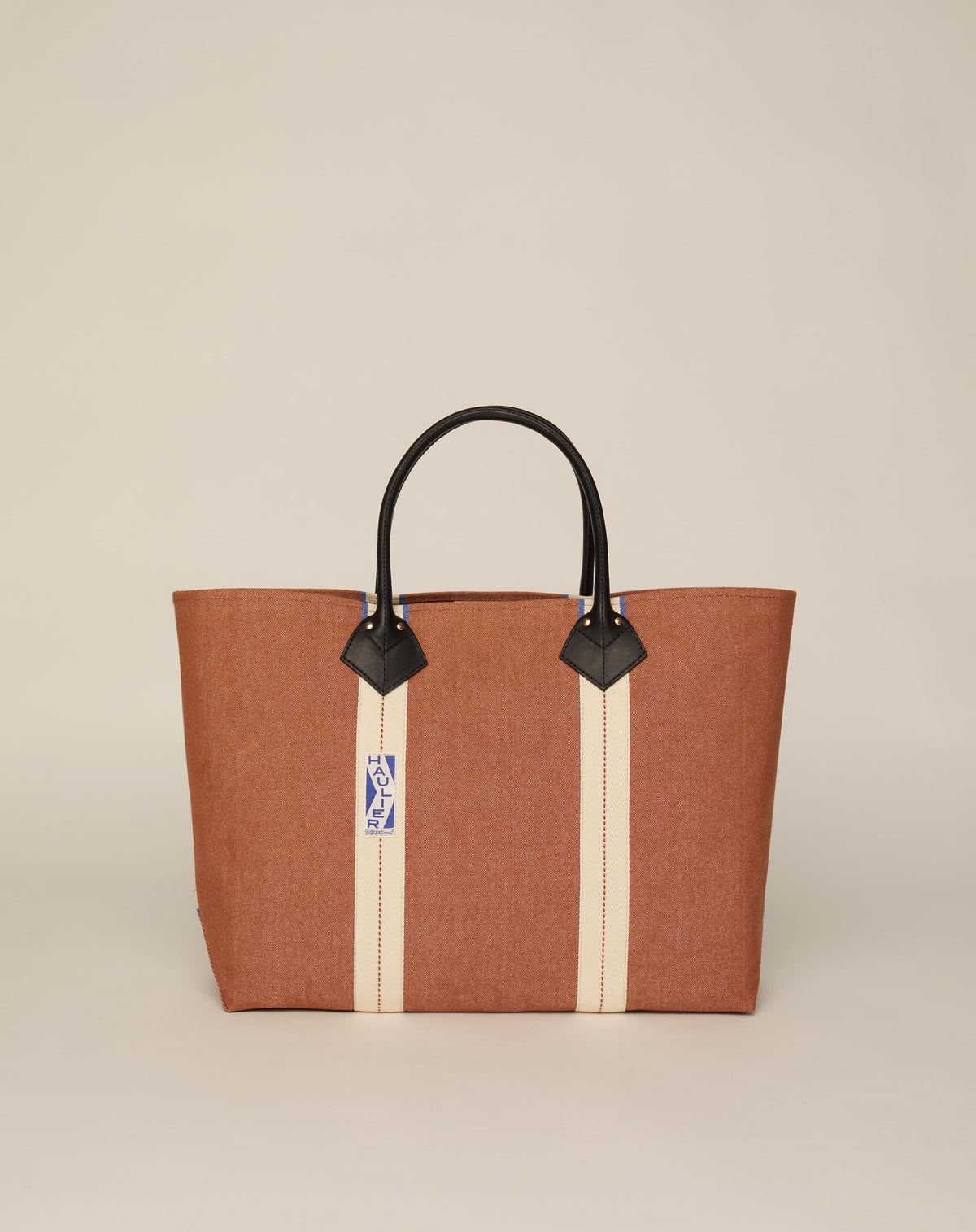 Image of classic canvas tote bag in tan colour with black leather handles and contrasting natural ecru stripes.