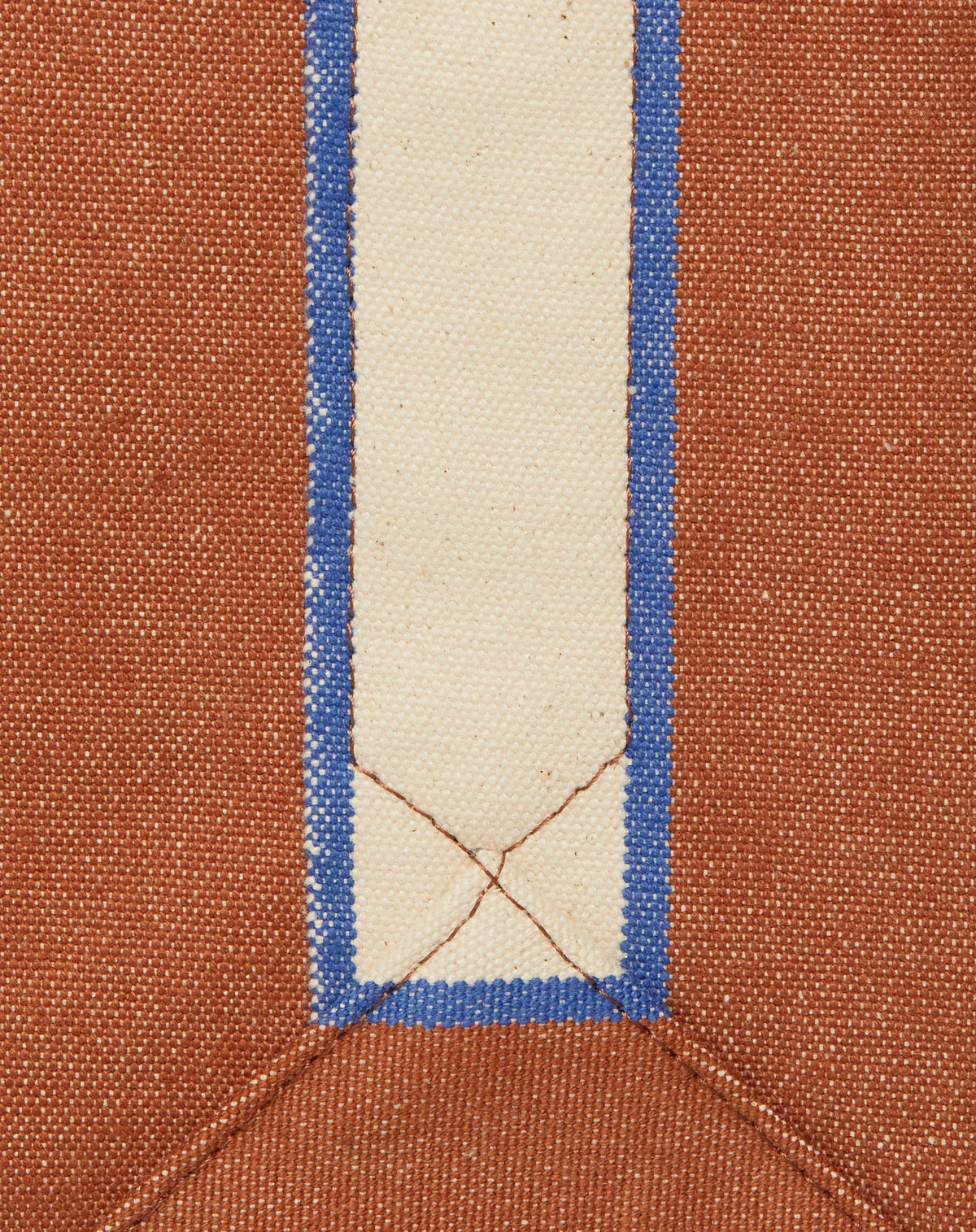 Close-up image of tan canvas with contrasting natural ecru stripe and stitching detail.