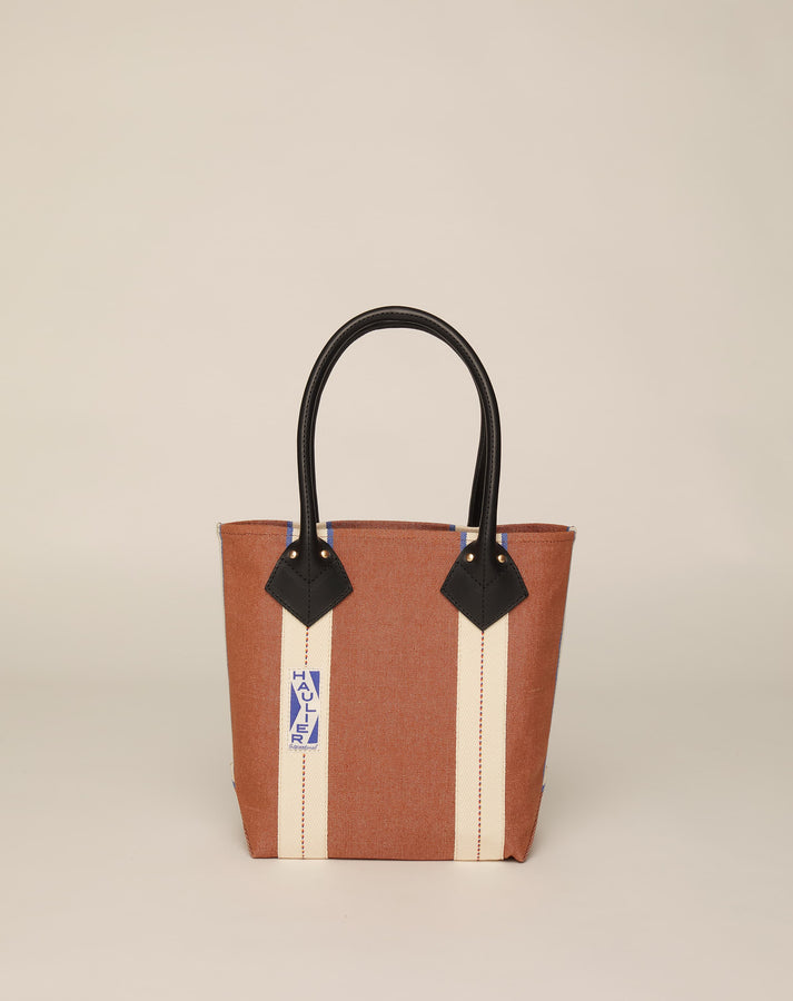 Image of small classic canvas tote bag in tan colour with black leather handles and contrasting stripes.